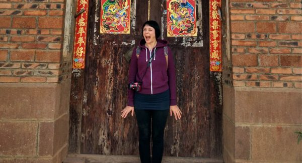 Blogger Alice standing in front of a chinese door in China