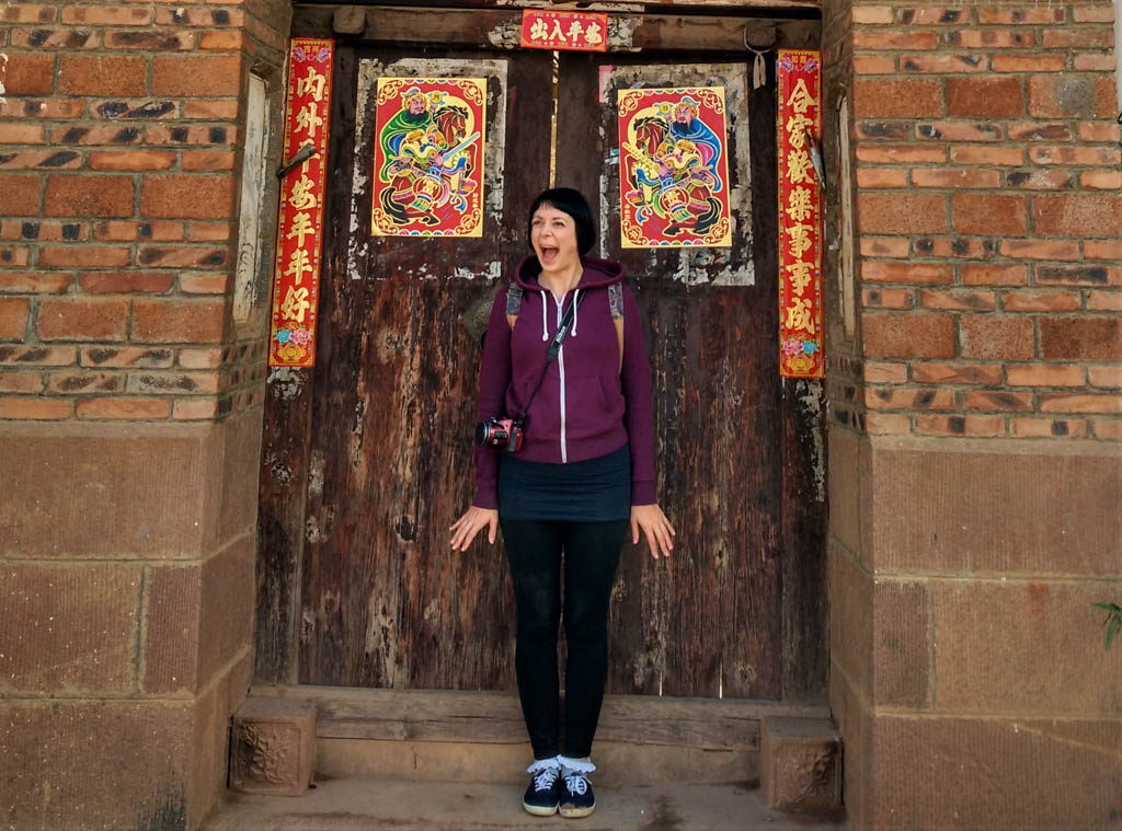Blogger Alice standing in front of a chinese door in China