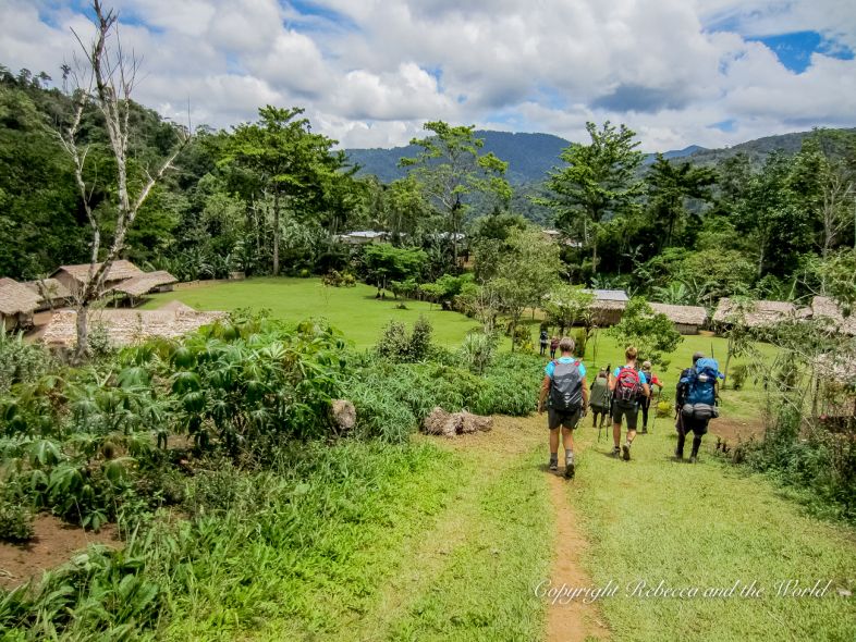 Three people walking along the Kokoda Track in Papua New Guinea