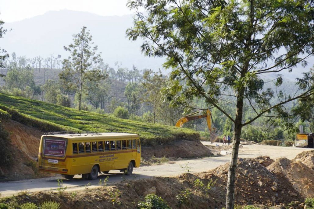 A bus in India going around a curve in a road