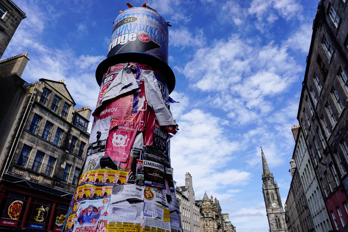 A pillar covered in Fringe posters advertising different shows