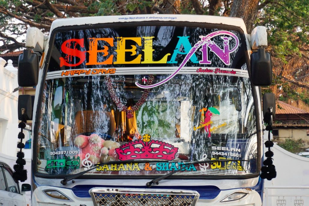 A bus in Kochi decorated with brightly colored stickers and has the word SEELAN across the top.