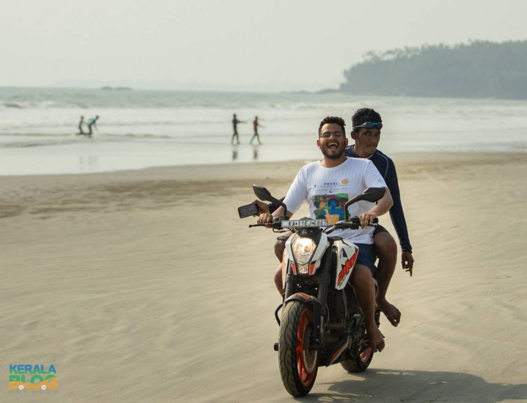 Two men on a motorbike on the beach