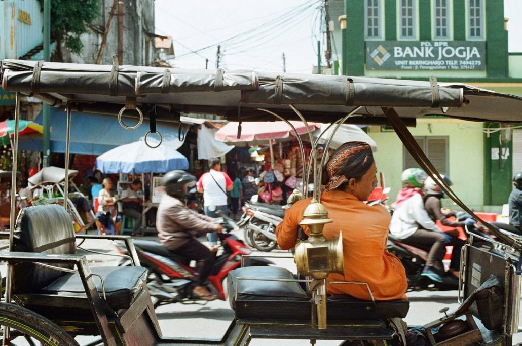 A tuk tuk driver in the busy streets of Yogyakarta Indoneis