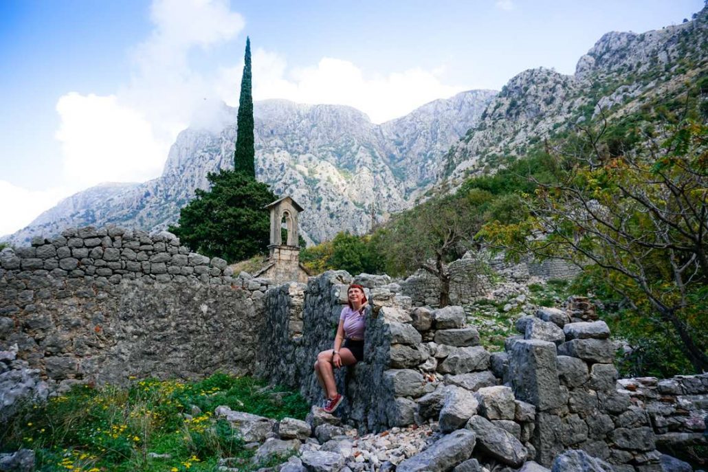 Photo of Alice resting at the ruins of St. John Church on the Ladder of Kotor
