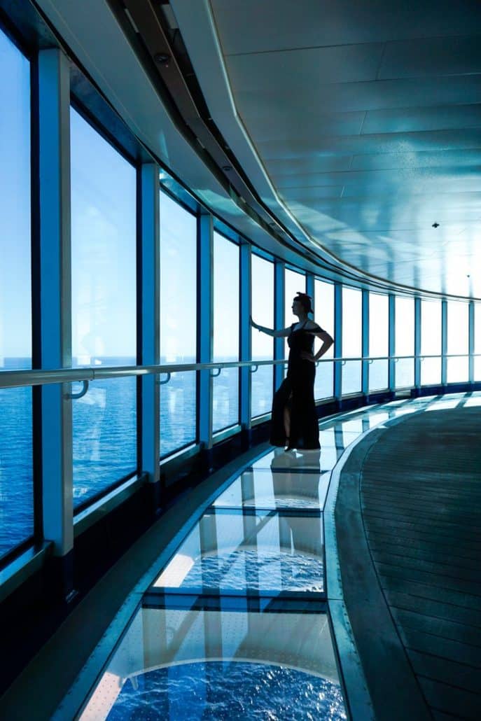 Photo of Alice standing on the glass floor in the Sea Walk looking out at the ocean