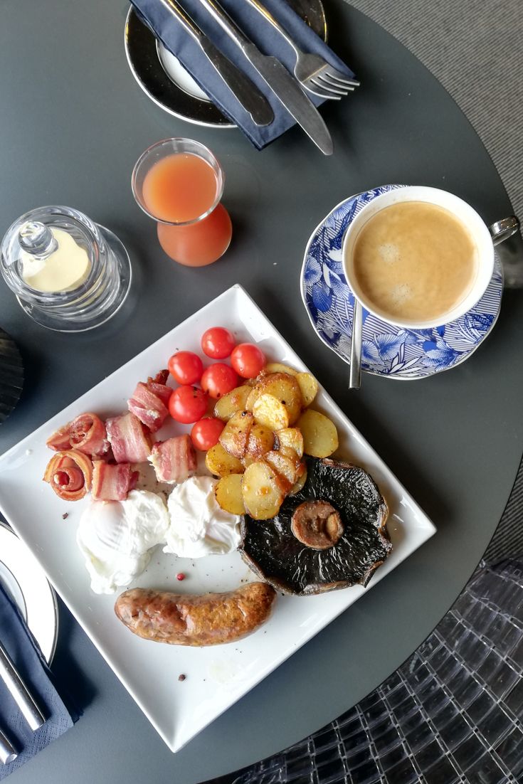 Full English cooked breakfast including tomatoes, mushrooms, potatoes, egg, bacon and sausage at The Square Hotel Brighton