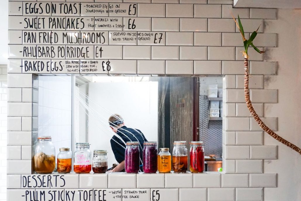 Looking through the serving hatch at the chef of Eat Your Greens Leeds