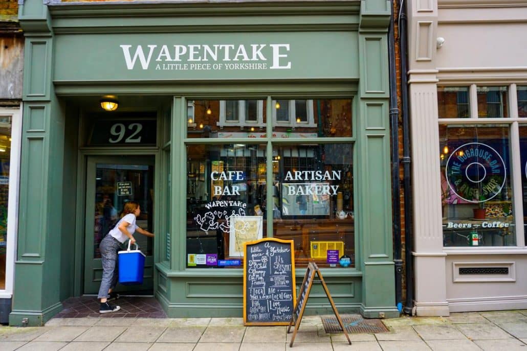 A lady walking into Wapentake pub and restaurant in Leeds Centre