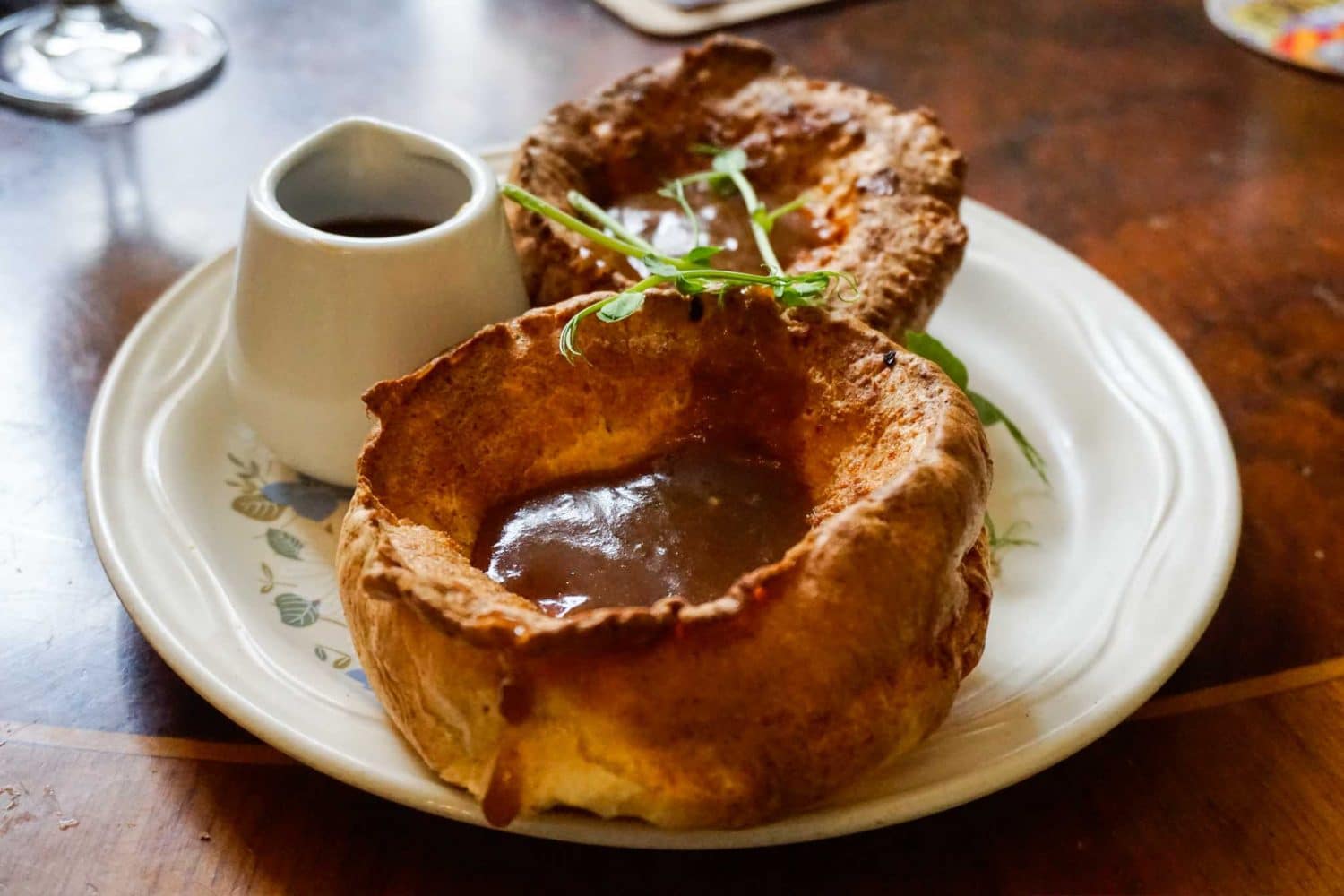 Discover a delicious close up of a big Yorkshire pudding filled with gravy and more to be poured into it in the best eateries and restaurants in Leeds City Centre