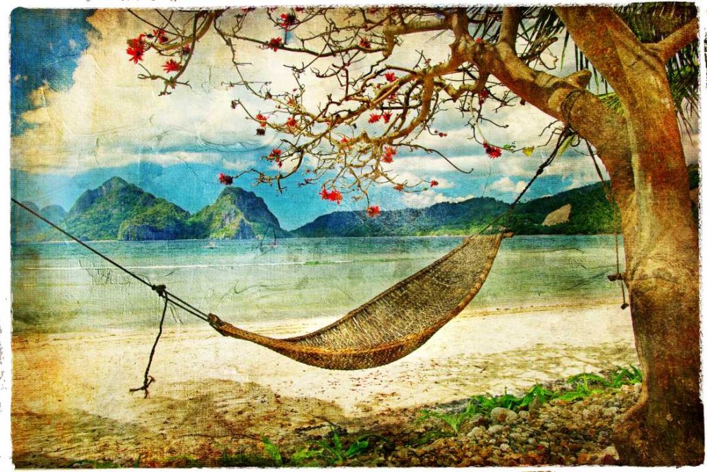 Travel postcard depicting a hammock attached to a blossoming tree along the beach with mountains in the background