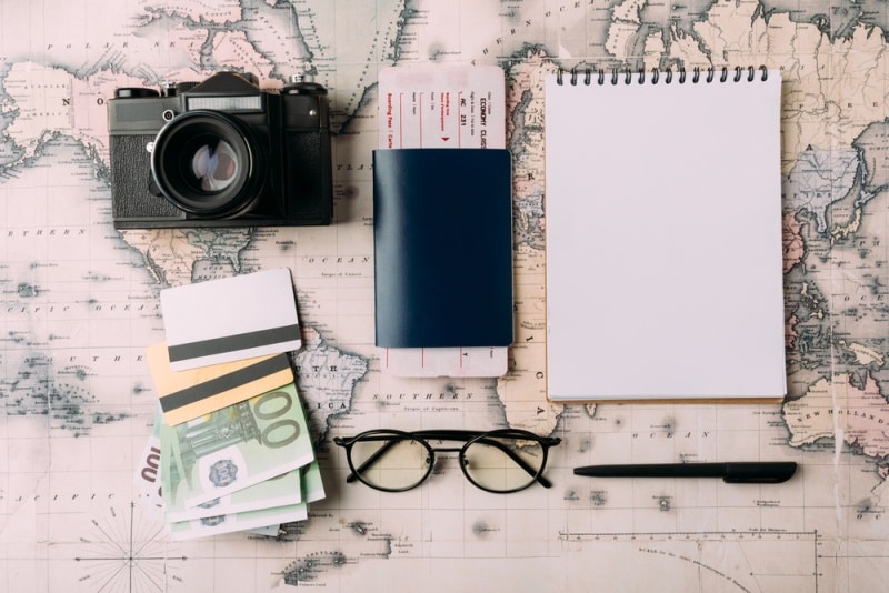 Photo of a traveler's passport, camera, money and travel journal getting ready to travel in Europe.