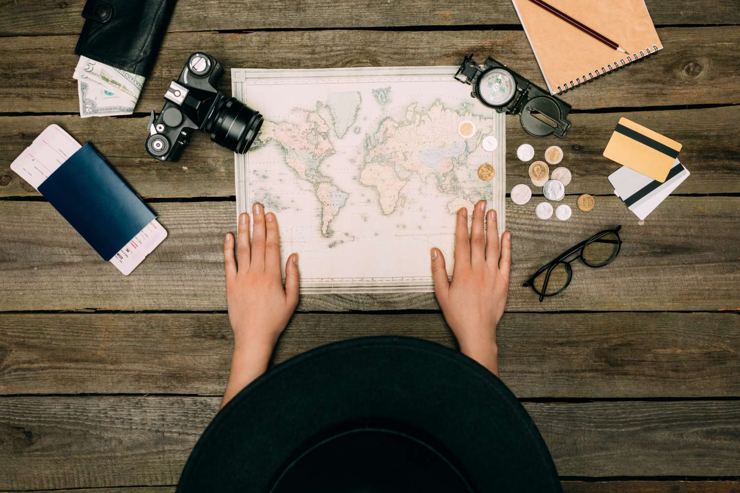 Solo female traveler planning her first time traveling out of the country with a map in front of her