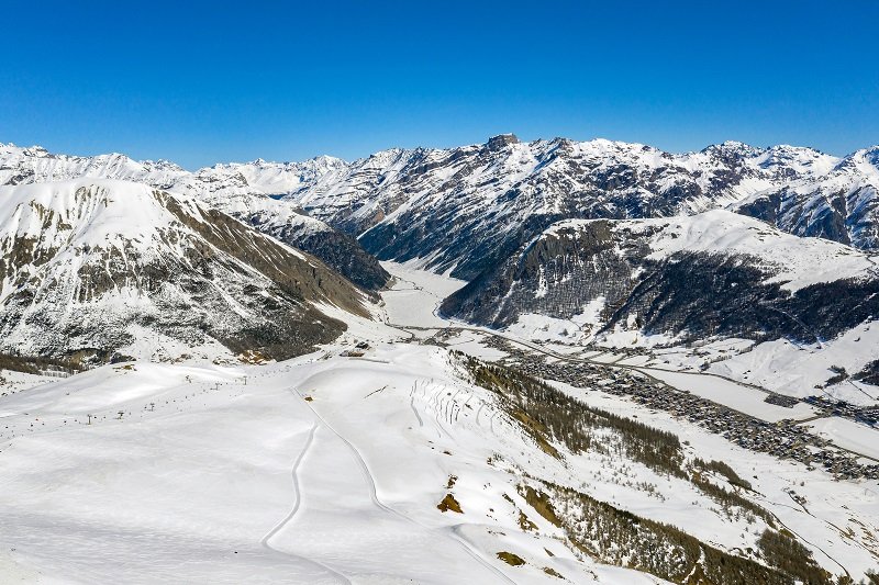 A Winter aerial panorama view of Livigno in Italy with its slopes and ski lifts